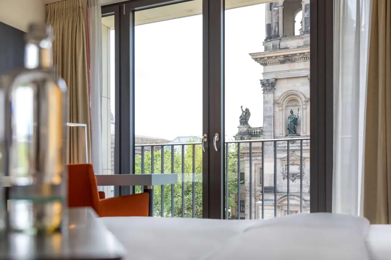 Widok z okna pokoju w Radisson Blu Berlin na zabytkową architekturę i zieleń.