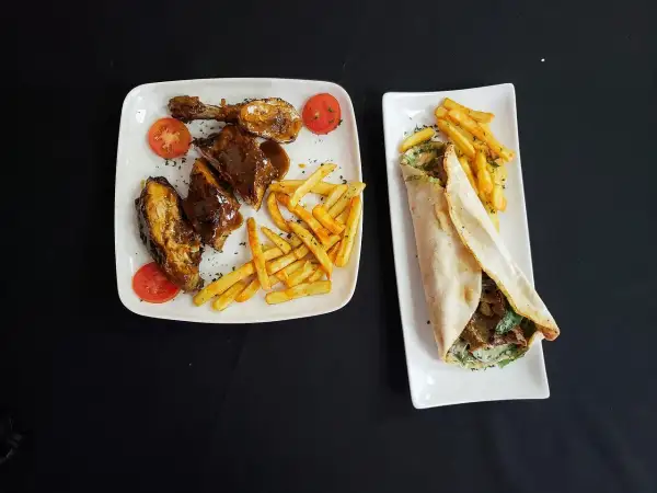 Dwa talerze z jedzeniem: żeberka w sosie z frytkami i pomidorkami, oraz wrap z mięsem i frytkami. Pytanie: halal co to?